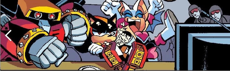 A panel from the Sonic the Hedgehog Archie comics of E-123 Omega, Rouge the Bat, and Shadow the Hedgehog. They're sitting in front of a TV. Omega looks excited, Shadow looks bored/grumpy, and Rouge is cheering animatedly, spilling popcorn onto Shadow.